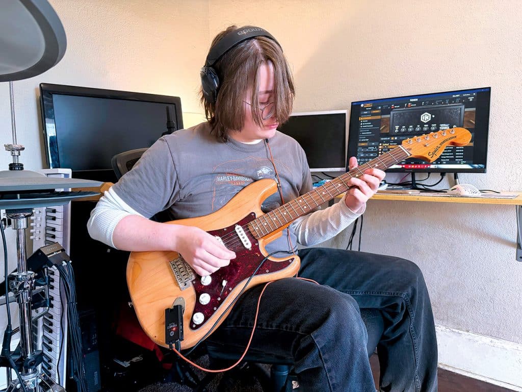A guitarist playing guitar using TONEX Plug